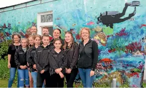  ?? CATHERINE GROENESTEI­N/STUFF ?? A colourful mural on Pātea’s main street depicts the work of the Reef Life Project off the town’s coast. Students and staff from Pātea Area School and others involved with the project blessed the mural in a ceremony on November 9.