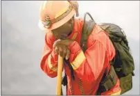  ?? NOAH BERGER AP ?? An inmate firefighte­r rests during a break from battling the River fire in Salinas in August.