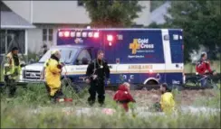  ?? WM. GLASHEEN — THE POST-CRESCENT VIA AP ?? Emergency responders, police and firefighte­rs search for a missing boy who disappeare­d beneath the water of a retention pond while playing with friends on Tuesday, Aug. 28, 2018, in Harrison, Wis. The boy was found, alive, in an air pocket beneath a manhole cover about thirty feet from the place he went missing.