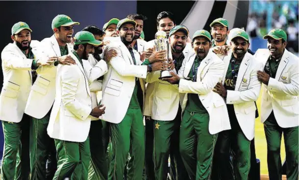  ??  ?? BOWLED OVER: Jubilant Pakistan with the ICC Champions Trophy after defeating India in the final the Oval