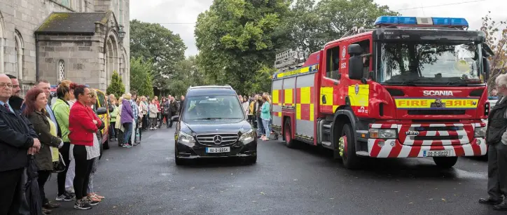  ??  ?? SUPERHERO: The hearse leaves the funeral of Ben Farrell, known as ‘Batman Ben’, flanked by a fire engine at the Church of the Sacred Heart in Arbour Hill. Photo: Tony Gavin