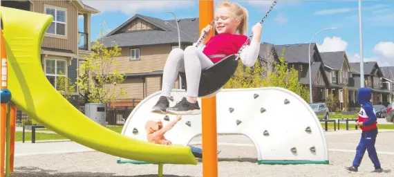  ?? GAVIN YOUNG ?? Cassidy Spragg enjoys the swings Saturday at the Midtown playground in Airdrie, where playground­s reopened the day before.