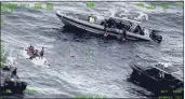  ?? SEVENTH U.S. COAST GUARD DISTRICT ?? People stand on a capsized boat, left, as some of its passengers are pulled up to a rescue boat, top, in the open waters northwest of Puerto Rico on Thursday.