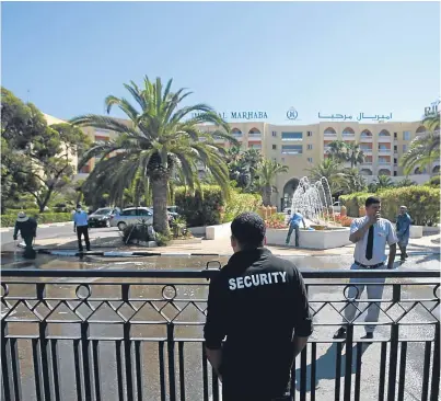  ?? Picture: AP. ?? A security officer guards the entrance to the Imperial Hotel the day after the attack.