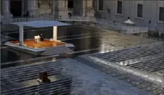  ?? Yara Nardi/Pool via AP ?? Pope Francis, in white, prays in an empty St. Peter’s Square, at the Vatican, on Friday. Francis compared the COVID-19 outbreak to an “unexpected, turbulent storm” as he prayed for the world.