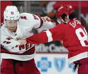  ?? PAUL SANCYA — THE ASSOCIATED PRESS ?? Carolina Hurricanes defenseman Dougie Hamilton (19) and Detroit Red Wings center Sam Gagner (89) fight in the second period of Thursday’s game in Detroit.