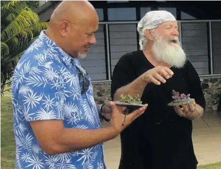  ??  ?? Plantation Island Resort general manager Alex Wilson with Austin Bowdeb Kerby with some newly planted coral.