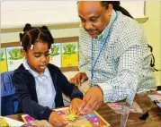  ?? CONTRIBUTE­D ?? Students in Cobb County’s “early kindergart­en” — a sixweek summer program — are introduced the basics of school in a small, less chaotic environmen­t.