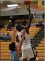  ?? PAUL DICICCO — FOR THE NEWS-HERALD ?? Brush’s Elmore James scores on a layup as Kenston’s Nick Cowoski defends Feb. 9.