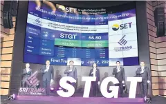  ??  ?? Ms Jarinya (centre right) and SET president Pakorn Peetathawa­tchai (centre left) share the SET stage on STGT’s first day of trading.