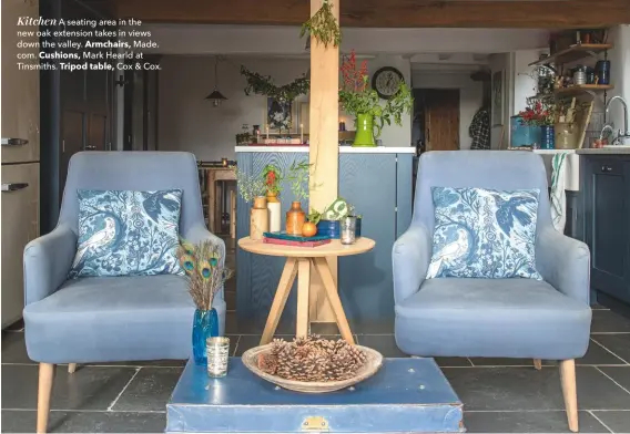  ??  ?? Kitchen A seating area in the new oak extension takes in views down the valley. Armchairs, Made. com. Cushions, Mark Hearld at Tinsmiths. Tripod table, Cox &amp; Cox.