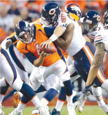  ?? JACK DEMPSEY/AP ?? Bears defensive end Roy Robertson-Harris sacks Broncos quarterbac­k Case Keenum in the first half Saturday night.