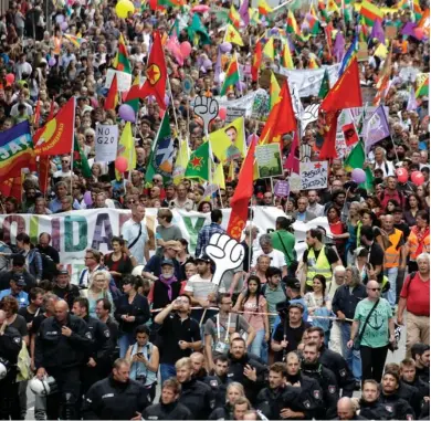  ?? (Photo by Michael Probst, AP) ?? Riot Police officers escort a protest rally against the G-20 summit in Hamburg, northern Germany, Saturday, July 8, 2017. The leaders of the group of 20 meet July 7 and 8.