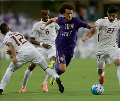  ?? Photo by Ryan Lim ?? Al Ain’s Omar Abdulrahma­n tries to go past El Jaish players during the first leg of the AFC Champions League semifinal at Hazza bin Zayed Stadium in Abu Dhabi on Tuesday night. —