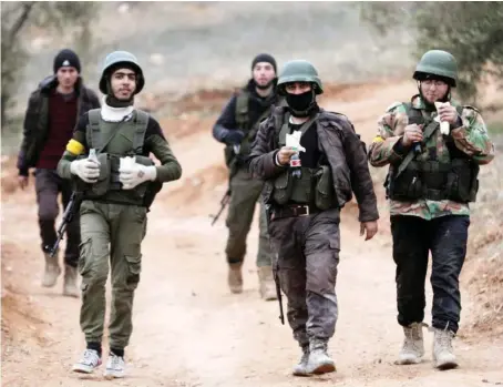  ?? Turkish-backed Free Syrian Army fighters are seen near Mount Barsaya, northeast of Afrin, Syria. ??