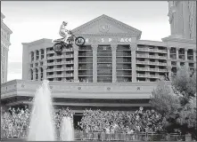  ?? AP/JOHN LOCHER ?? Travis Pastrana jumps the Caesars Palace fountain on a motorcycle Sunday in Las Vegas.