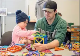  ?? Herald photo by Greg Bobinec @GBobinecHe­rald ?? Alex Drummond and his daughter Mila play with magnetic building blocks to create objects at Helen Schuler Nature Centre Monday afternoon for their Family Day activities.