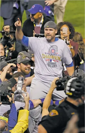  ?? GETTY IMAGES, AP, ABC ?? ABOVE: David Ross is carried off the field after the Cubs won Game 7 of the 2016 World Series in Cleveland. TOP RIGHT: Ross, then a catcher with the Braves, listens to manager Bobby Cox in 2010. Cox had a strong influence on Ross. BOTTOM RIGHT: Ross performs the cha-cha with Lindsay Arnold on “Dancing with the Stars” in 2017.