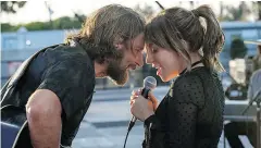  ?? NEAL PRESTON / WARNER BROS. VIA AP ?? Bradley Cooper and Lady Gaga in a scene from the latest reboot of A Star is Born. The film picked up five Golden Globe nomination­s on Thursday.