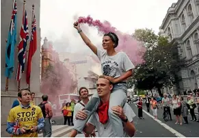  ?? AP ?? Protesters carry a flare near the Cenotaph in central London yesterday.