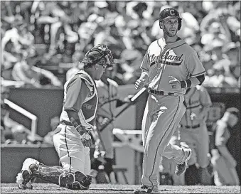  ?? [JOHN SLEEZER/KANSAS CITY STAR] ?? The Indians’ Yan Gomes scores on a single by Carlos Santana in the fifth inning as Royals catcher Salvador Perez looks on.