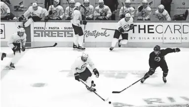  ?? ROB SCHUMACHER/THE REPUBLIC ?? Coyotes center Frederik Gauthier is pressured by left wing Dryden Hunt during a scrimmage at Gila River Arena in Glendale on Wednesday.