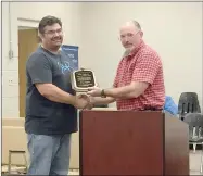  ?? COURTESY PHOTO ?? Allen Williams, Prairie Grove School District superinten­dent, right, presents a plaque of appreciati­on to School Board President Eric Walker at the board meeting last week. Walker has resigned his position on the Board.