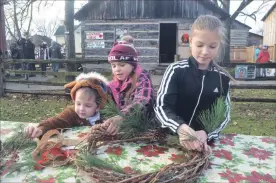  ?? MIKE ZETTEL PORT COLBORNE LEADER ?? Abel Nagy, 3; Jaylynn Dempsey, 6; and Berkley Dempsey, 10, work together to create a wreath at Sunday’s Grand Old Christmas event at Port Colborne Historical and Marine Museum.