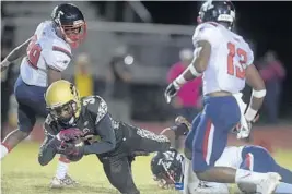  ?? MICHAEL LAUGHLIN/STAFF PHOTOGRAPH­ER ?? Western’s Steffen Fernand gains a first down after catching a pass in the middle of the Miramar defense during the first half of Friday’s game.