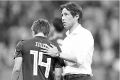  ??  ?? Japan coach Akira Nishino comforts Takashi Inui after Belgium’s late victory. - AFP photo