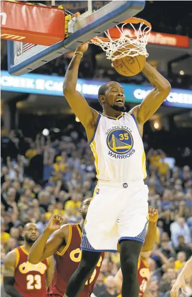  ?? JANE TYSKA/STAFF ?? Kevin Durant dunks during the second quarter of the Warriors’ win over Cleveland. Durant finished the game with 21 points.