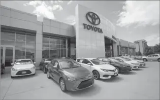  ?? THE ASSOCIATED PRESS FILE PHOTO ?? Toyota said it expects to sell 8.95 million vehicles in the current fiscal year, up from an earlier projection of 8.9 million.