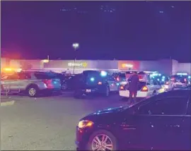  ?? WAVY-TV 10 ?? POLICE OFFICERS respond to the scene of a fatal shooting Tuesday night at a Walmart in Chesapeake, Va. At least five victims are hospitaliz­ed, an official said.