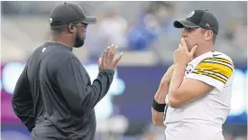  ??  ?? Steelers quarterbac­k Ben Roethlisbe­rger, right, listens to coach Mike Tomlin during a preseason game.