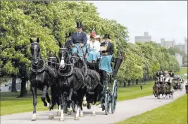  ??  ?? Alastair Grant The Associated Press Horse-drawn carriages make their way down the Long Walk from Windsor Castle in Windsor, England, on Friday. The castle will host the royal wedding of Prince Harry and Meghan Markle on May 19.