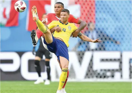  ?? AP ?? Sweden’s Marcus Berg (front) is challenged by Switzerlan­d’s Manuel Akanji during their round of 16 match in the World Cup. —