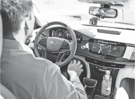  ?? JARRAD HENDERSON/USA TODAY ?? Reporter Nathan Bomey test drives a 2018 Cadillac CT6 featuring the Super Cruise system.