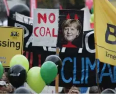  ?? SEAN GALLUP/GETTY IMAGES ?? Activists protest coal energy in Germany, where Canada is pushing for a move to clean energy sources such as wind and solar.