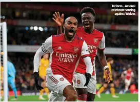  ?? ?? In form…Arsenal celebrate scoring againstWol­ves