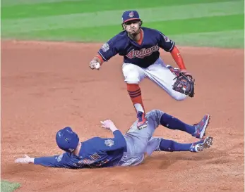  ?? DAVID RICHARD, USA TODAY SPORTS ?? Indians shortstop Francisco Lindor forces out Chris Coghlan during last year’s epic Game 7 of the World Series, won by the Cubs in 10 innings. Could 2017 bring a rematch?