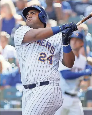  ?? GETTY IMAGES ?? The Brewers’ Jesus Aguilar connects on a blast in the eighth inning for his second home run against the Braves on Sunday.