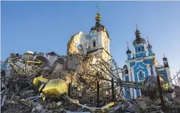  ?? EVGENIY MALOLETKA AP ?? A cupola lies on the ground in front of the Orthodox Church that was destroyed by Russian forces in the village of Bogorodych­ne, Ukraine, on Saturday.