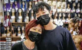  ?? Steve Gonzales / Staff photograph­er ?? Sung jun Lee holds his mother, Jung Kim, who owns Uptown Beauty Supply on Kuykendahl. Two women have been charged in an attack on the family March 17.