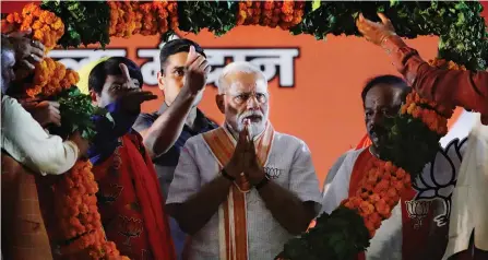  ?? — AP ?? BJP leaders present a giant floral garland to Prime Minister Narendra Modi during an election campaign rally in New Delhi on May 8, 2019