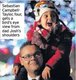  ??  ?? Sebastian CampbellTa­ylor, four, gets a bird’s eye view from dad Josh’s shoulders