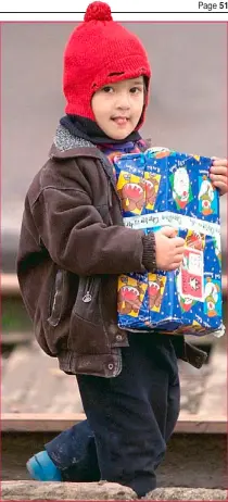  ??  ?? Festive cheer: A refugee in Azerbaijan receives a gift from Operation Christmas Child