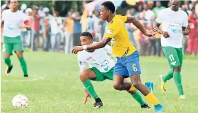  ?? ARNOLD/PHOTOGRAPH­ER PHOTO BY KAVARLY ?? Rusea’s High’s Kenroy Campbell (second right) looking to get the ball ahead of Alwayne Hill of Frome Technical during a recent ISSA/WATA daCosta Cup match at the Collin Miller Sports Complex.