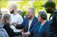  ?? SARAH GORDON/THE DAY ?? Mayor Michael Passero joins other community members greeting students as they arrive for the first day of school on Thursday at Bennie Dover Jackson Middle School in New London.