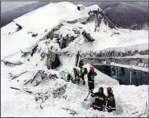  ??  ?? Frantic: Rescuers dig their way down to the hotel
