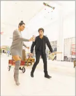  ?? Tony Dube / Contribute­d photo ?? Ashley Iaconetti and Jared Haibon, of the Bachelor franchise, pull a wagon with their shopping choices. The pair were taking part in a contest pitting area celebritie­s against each other in a shopping event to win up to $5,000 for a favorite charity in 30 minutes.